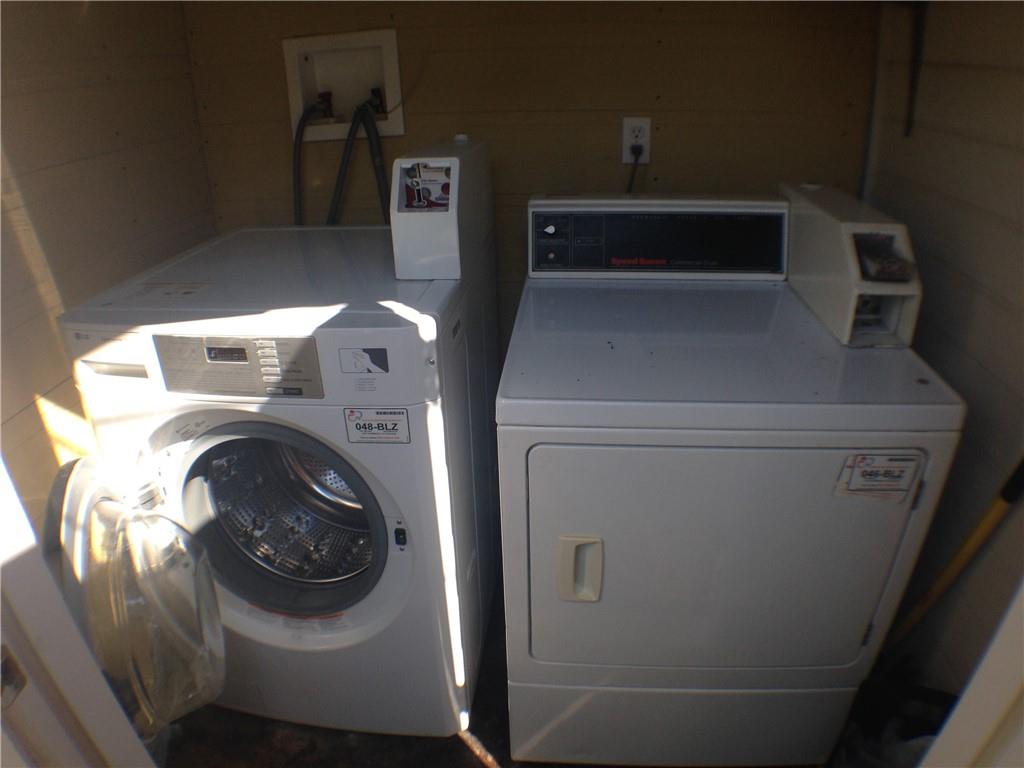 906 West 22nd Street, Unit 4 Austin, TX 78705 - Photo 5 of 6 Community laundry room featuring washer and clothes dryer and wooden walls