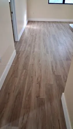 a view of hallway with wooden floor