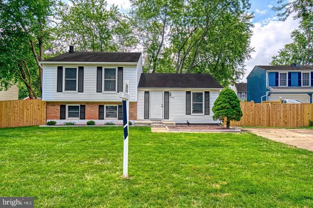 a view of a house with a yard and sitting area
