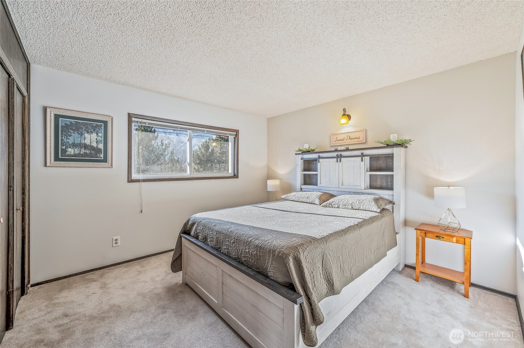 2314 Westwick Road Wenatchee, WA 98801 - Photo 16 of 37 a bedroom with a bed and painting on the wall