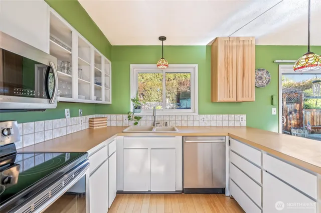 a kitchen with a sink stove and microwave