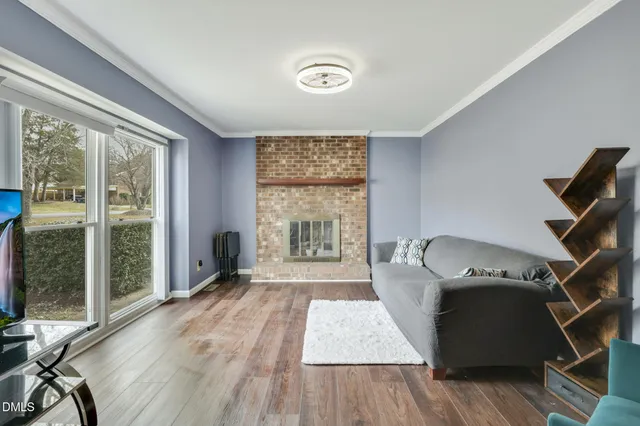 a living room with a bed furniture and a window