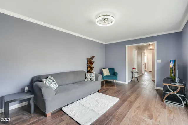 a living room with furniture and wooden floor