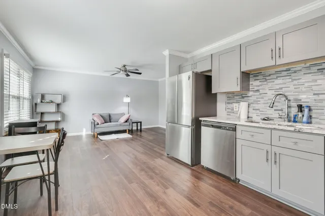 a kitchen with refrigerator and cabinets