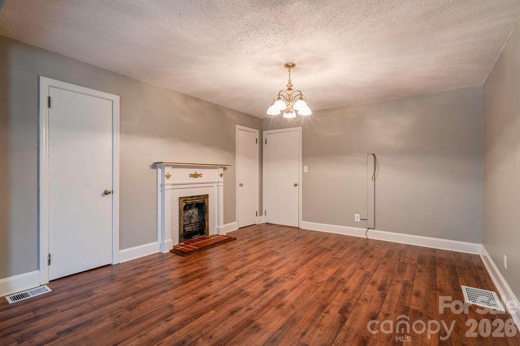 714 Linwood Road Kings Mountain, NC 28086 - Photo 14 of 26 a view of empty room with wooden floor fireplace and window