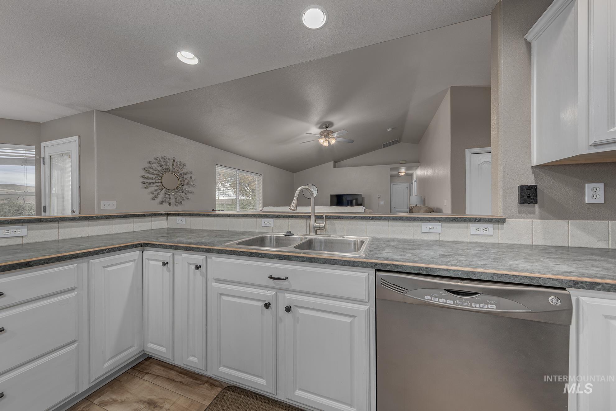 890 Jenkins Creek Road Weiser, ID 83672 - Photo 15 of 45 Kitchen featuring white cabinetry, stainless steel dishwasher, lofted ceiling, a ceiling fan, and recessed lighting