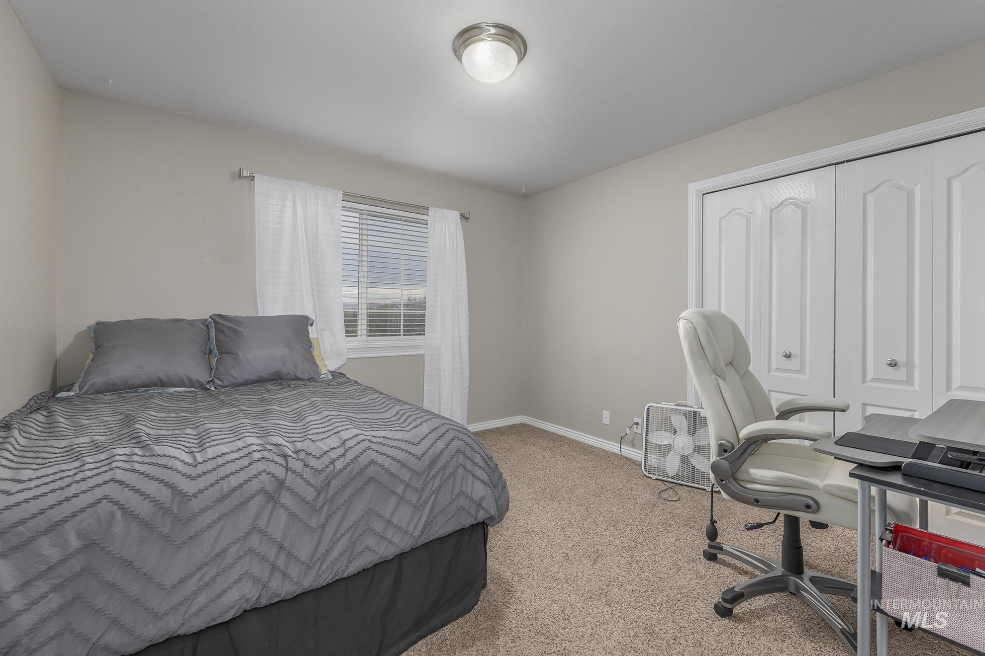 890 Jenkins Creek Road Weiser, ID 83672 - Photo 20 of 45 Bedroom with light colored carpet and a closet