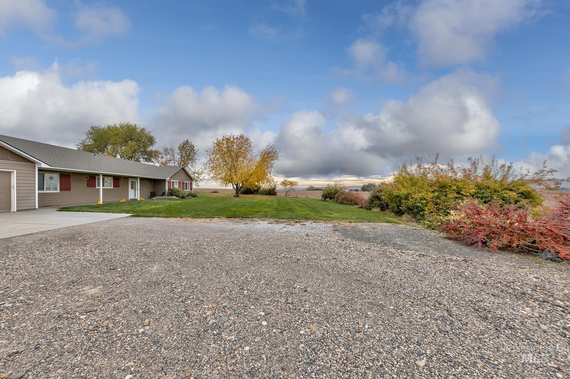 890 Jenkins Creek Road Weiser, ID 83672 - Photo 28 of 45 View of grassy yard featuring concrete driveway and a garage