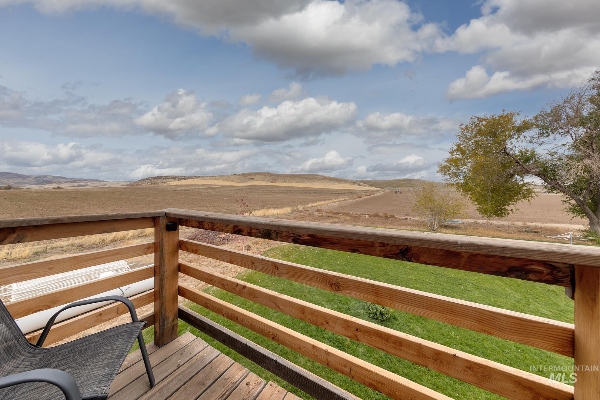 890 Jenkins Creek Road Weiser, ID 83672 - Photo 36 of 45 Wooden deck featuring a lawn