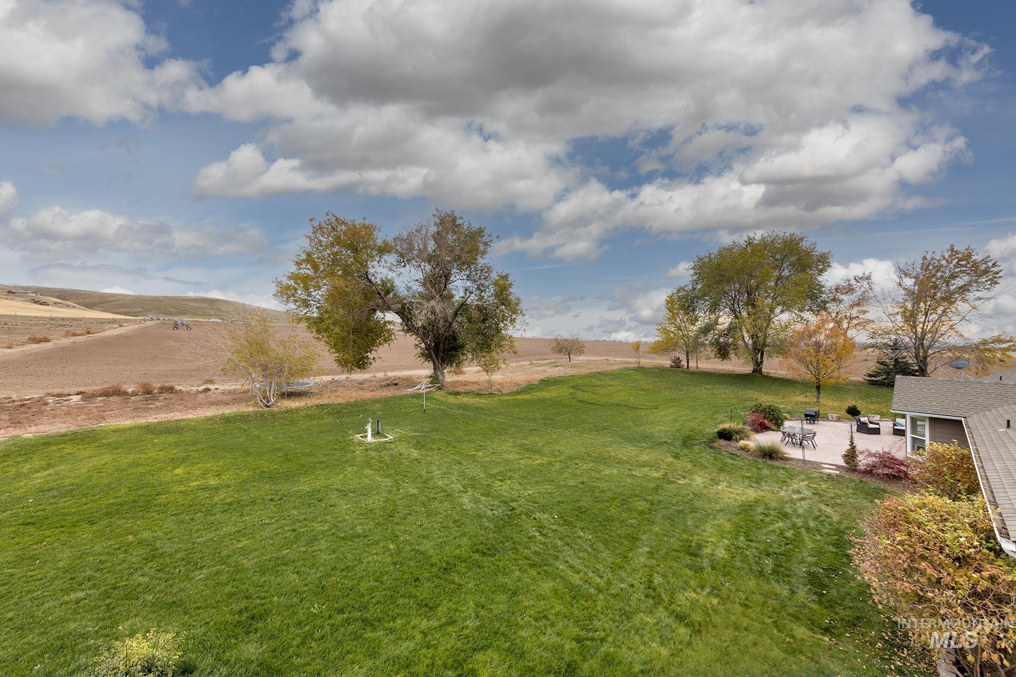 890 Jenkins Creek Road Weiser, ID 83672 - Photo 37 of 45 View of grassy yard with a rural view and a patio