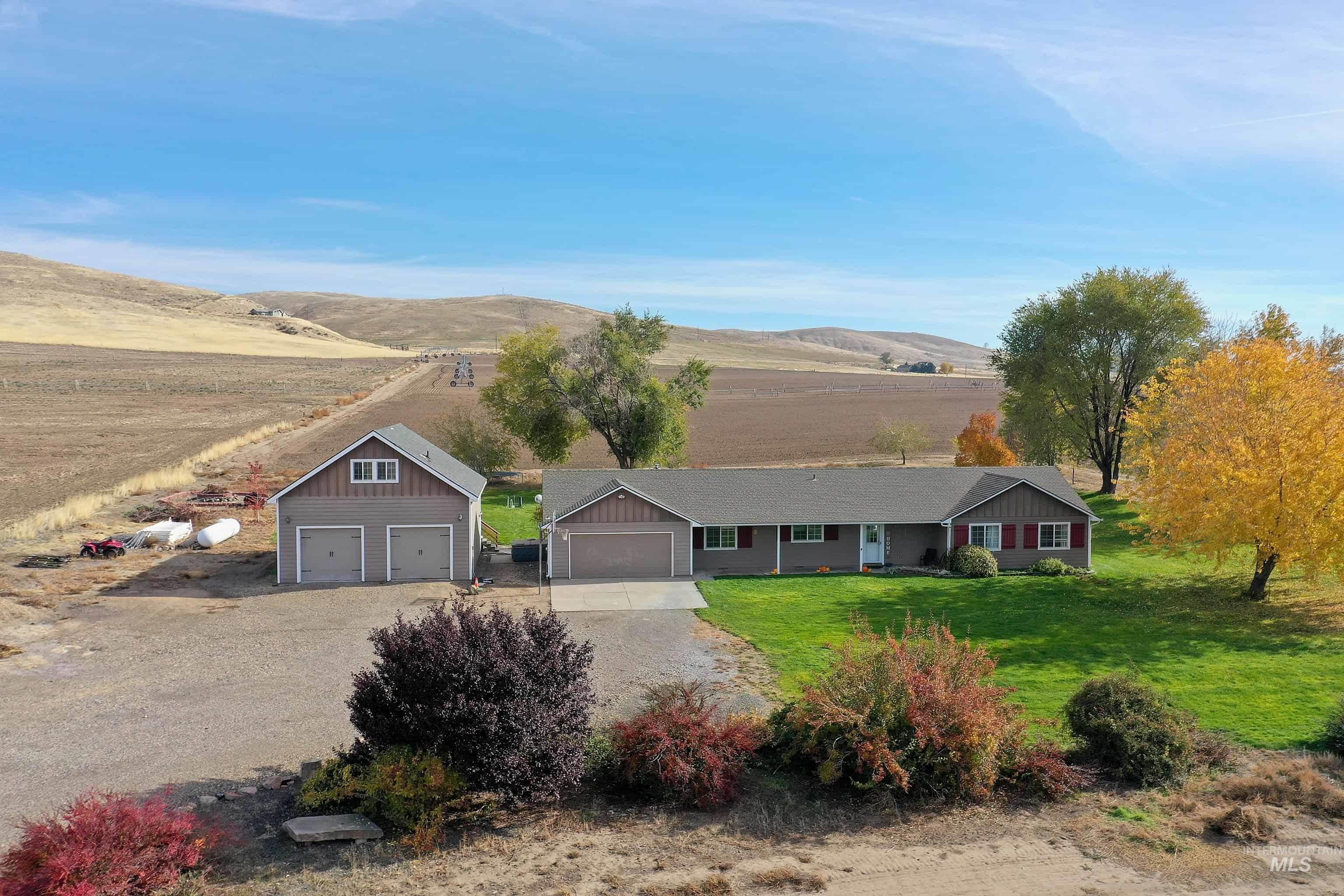 890 Jenkins Creek Road Weiser, ID 83672 - Photo 45 of 45 Ranch-style house with driveway, a front lawn, a mountain view, and a rural view