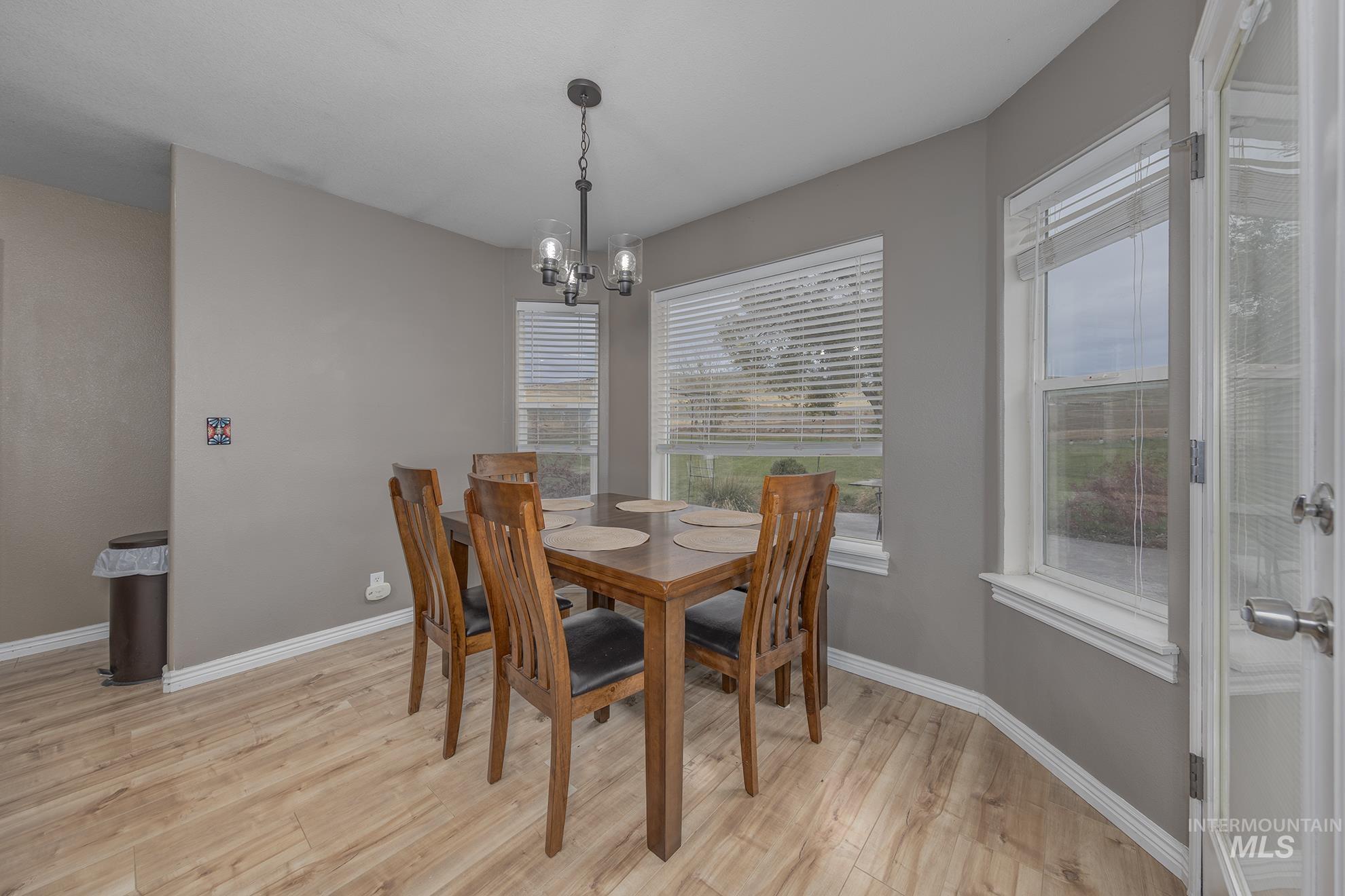890 Jenkins Creek Road Weiser, ID 83672 - Photo 10 of 45 Dining room with light wood-style flooring and a chandelier