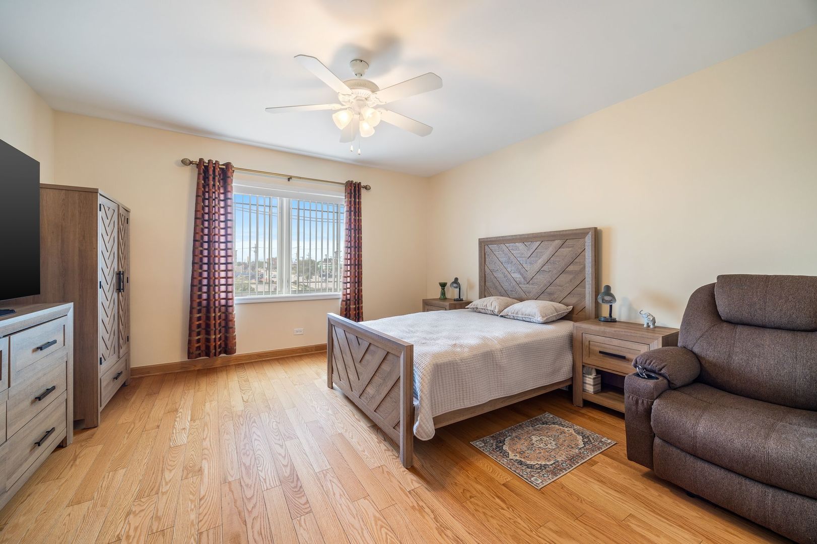 77 North Wolf Road, Unit 309 Northlake, IL 60164 - Photo 16 of 25 a bedroom with a bed couch and a window