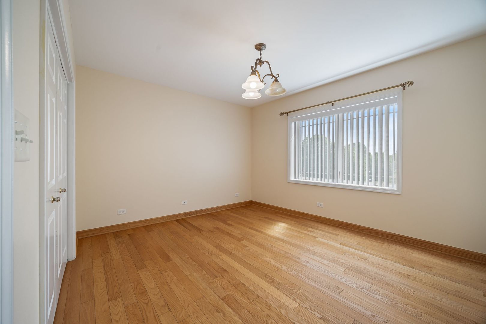 77 North Wolf Road, Unit 309 Northlake, IL 60164 - Photo 21 of 25 a view of an empty room with wooden floor and a window