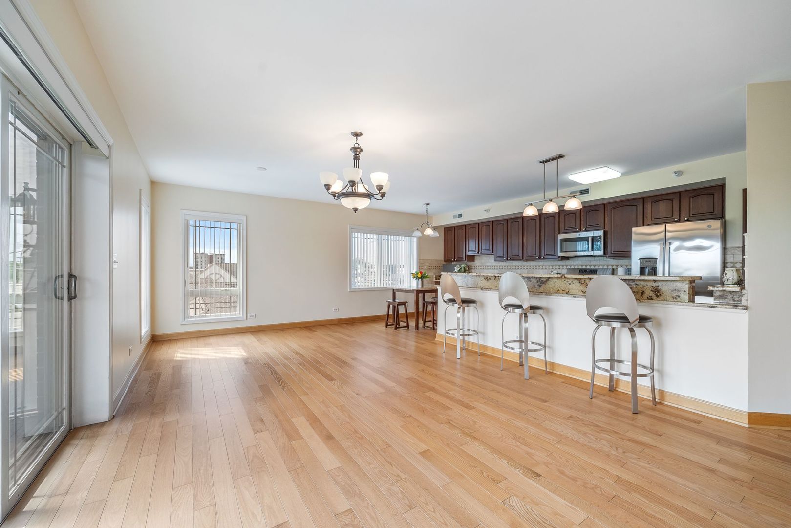 77 North Wolf Road, Unit 309 Northlake, IL 60164 - Photo 5 of 25 a view of a dining room with furniture and wooden floor