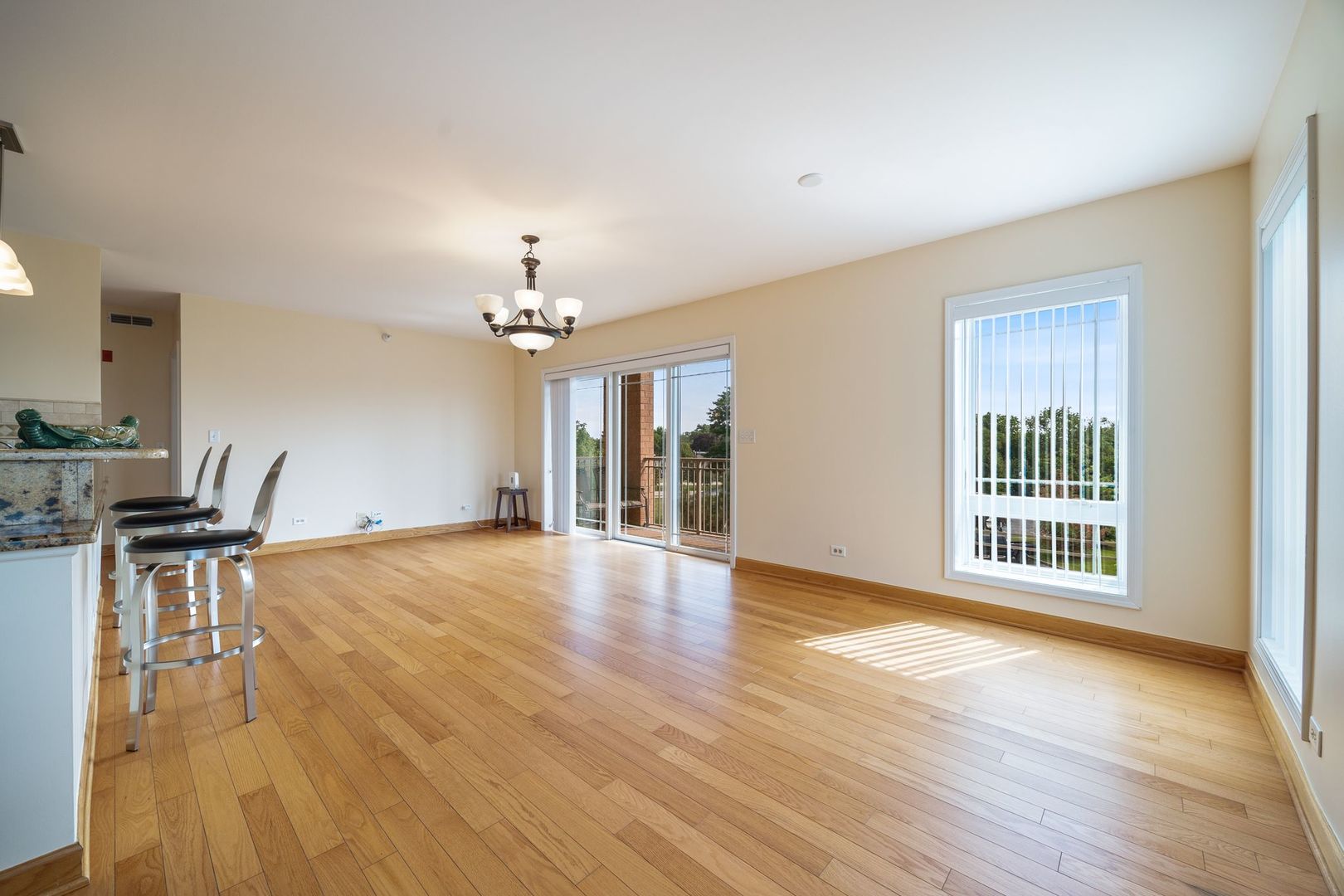 77 North Wolf Road, Unit 309 Northlake, IL 60164 - Photo 9 of 25 a view of an empty room with a window and wooden floor