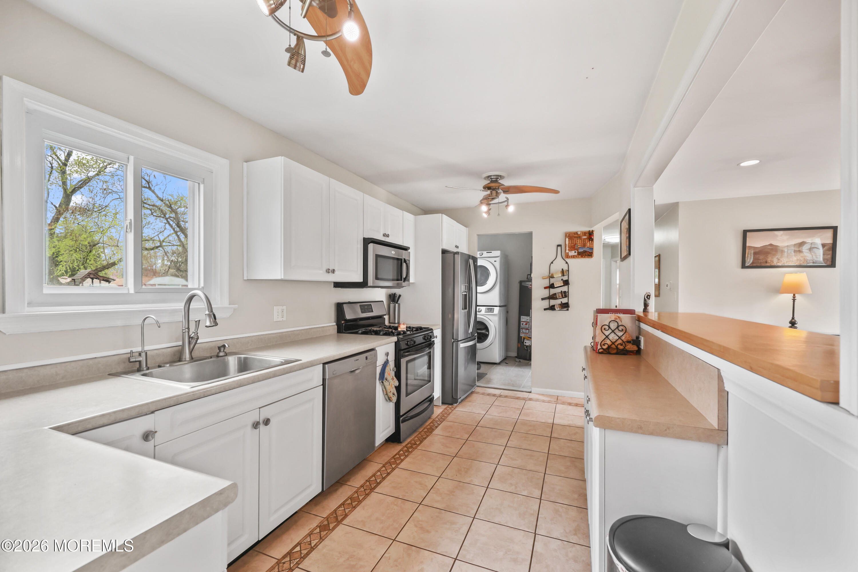9 Maple Lane Howell, NJ 07731 - Photo 3 of 32 a large white kitchen with a window and stainless steel appliances