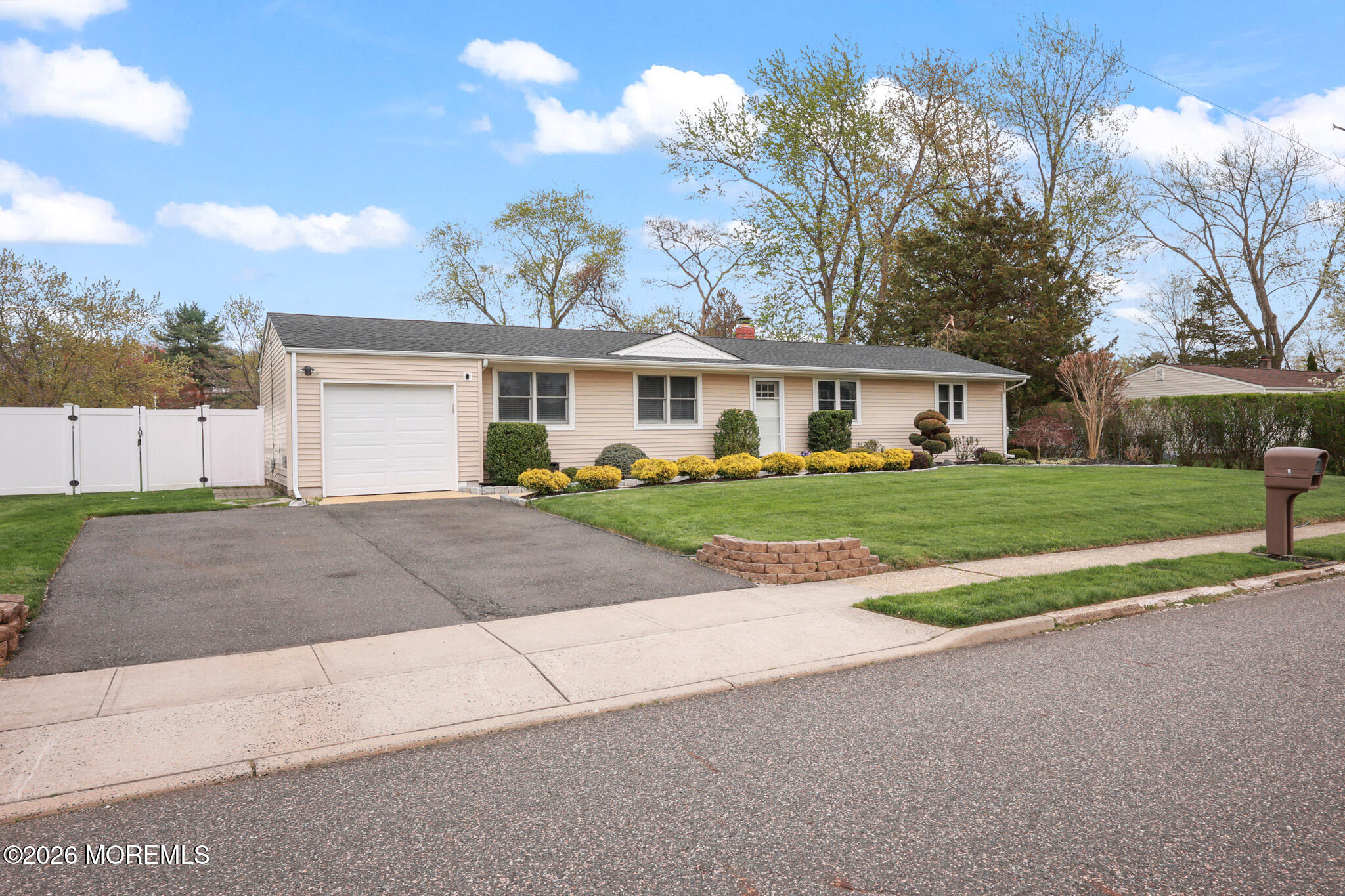 9 Maple Lane Howell, NJ 07731 - Photo 32 of 32 a front view of a house with a yard and garage