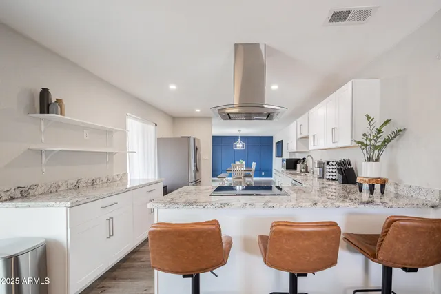 a kitchen with a stove a refrigerator and a sink
