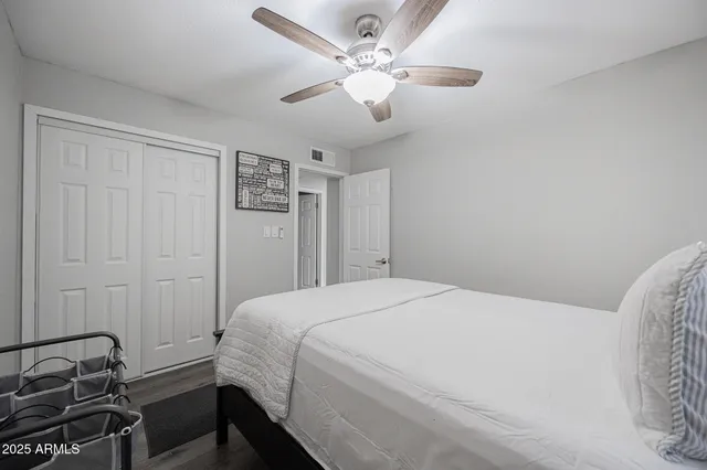 a bedroom with a bed and a night stand