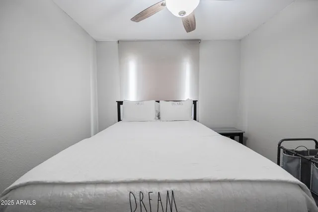 a living room with a bed furniture and a window