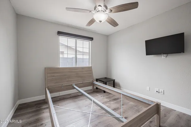 a view of an empty room with a ceiling fan