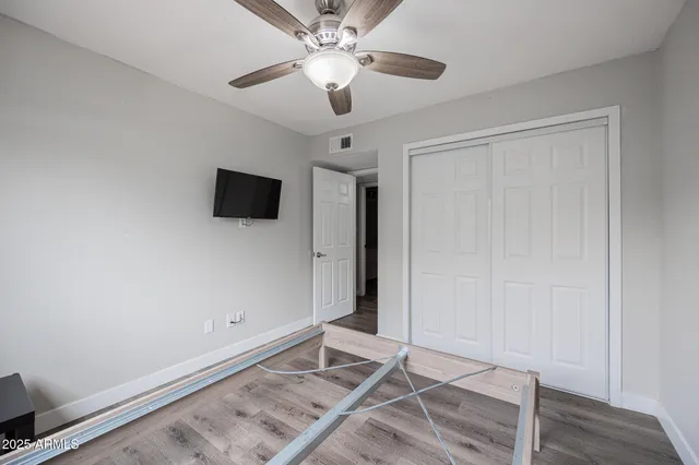 a bathroom with a toilet sink vanity and mirror