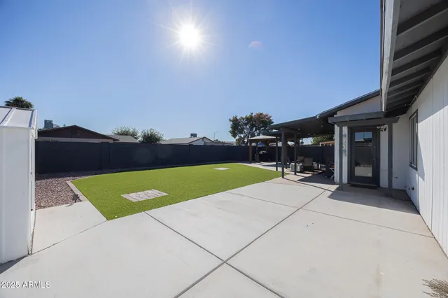 a view of a backyard with sitting area