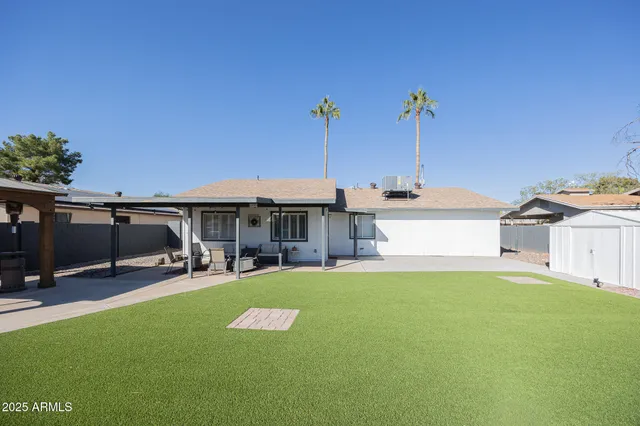 a view of a house with backyard and patio