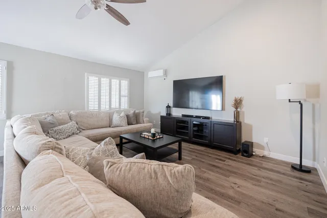 a living room with furniture and a wooden floor