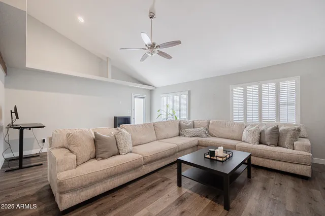 a living room with furniture and kitchen view