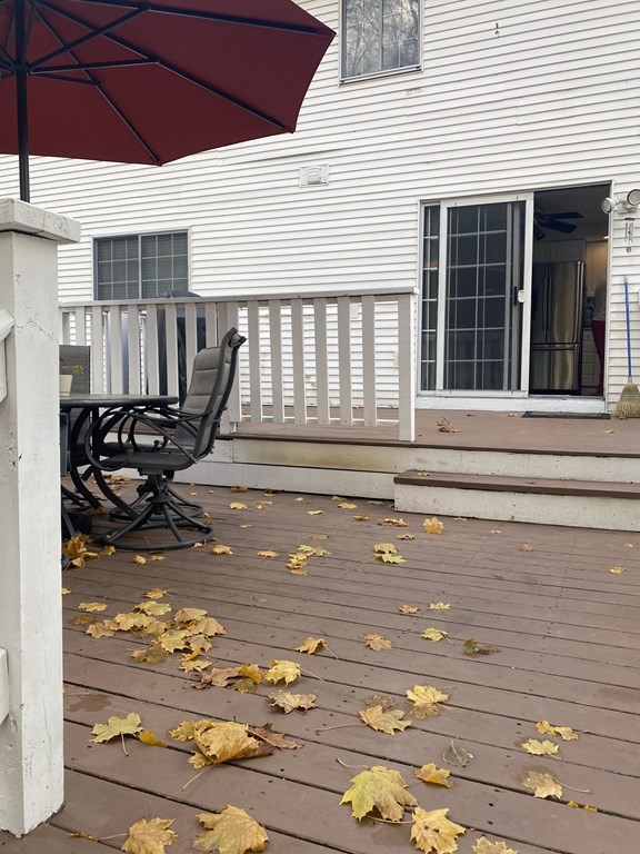 1 Jonathan Circle Worcester, MA 01604 - Photo 8 of 31 a view of a patio with table and chairs under an umbrella