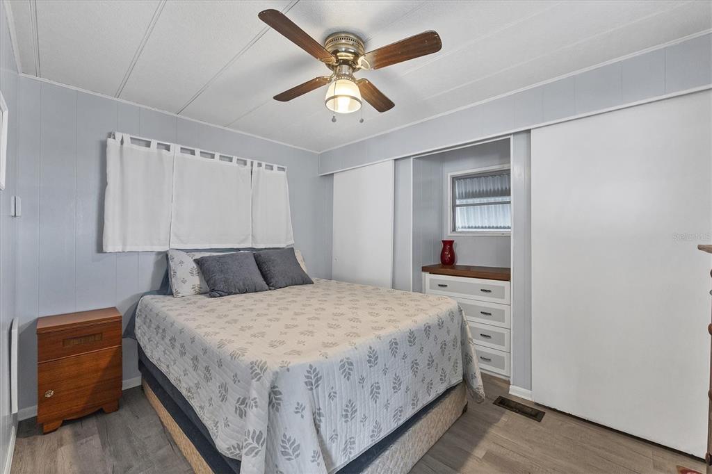 4114 10th St Court East Ellenton, FL 34222 - Photo 14 of 44 a bedroom with a bed and a chandelier