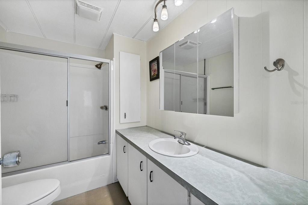 4114 10th St Court East Ellenton, FL 34222 - Photo 16 of 44 a bathroom with a sink double vanity granite tub and shower