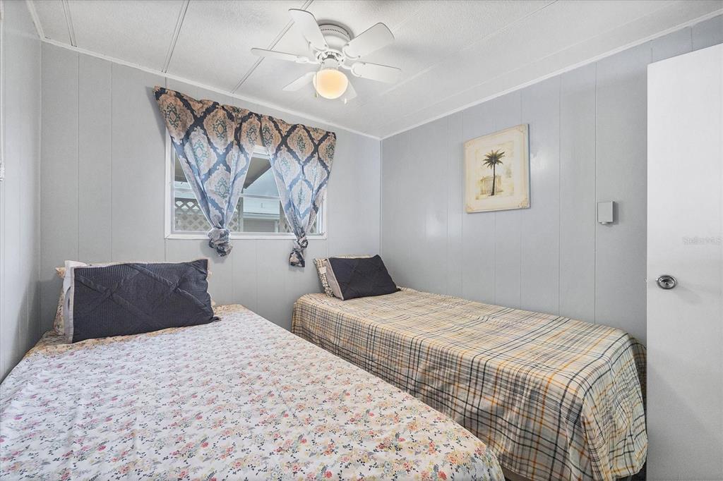 4114 10th St Court East Ellenton, FL 34222 - Photo 18 of 44 a bedroom with a bed and a chandelier