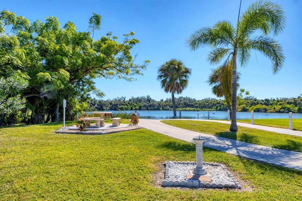 4114 10th St Court East Ellenton, FL 34222 - Photo 39 of 44 a view of a swimming pool with a table and chairs