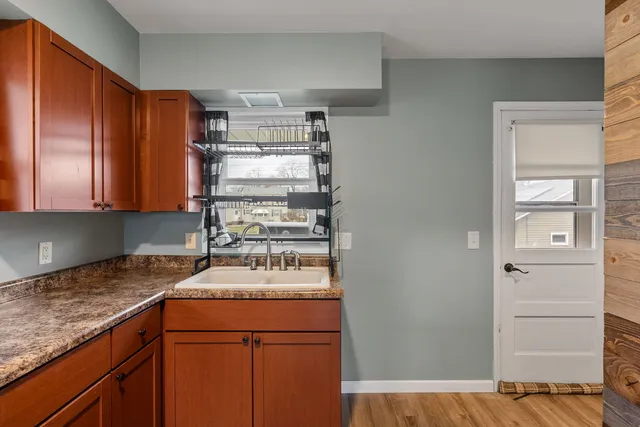 a kitchen with a refrigerator and a stove top oven