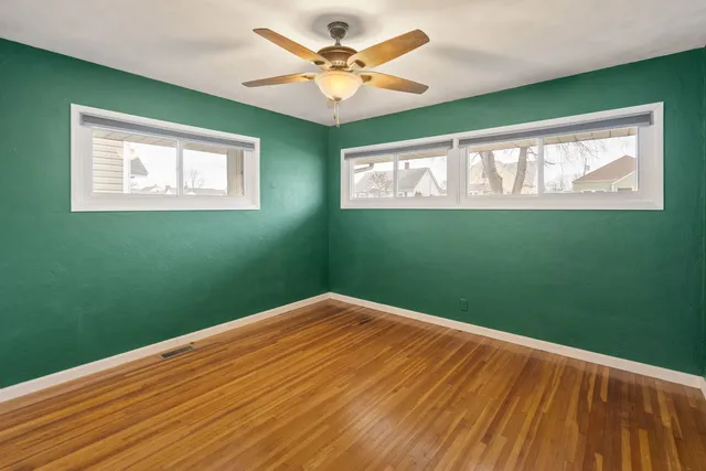 a view of a big room with window and fan