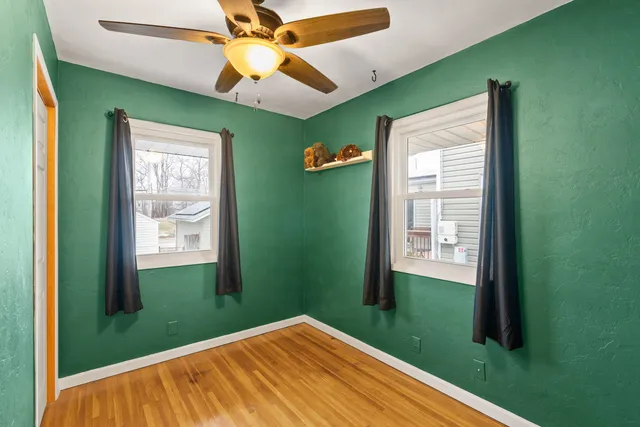 a view of a bedroom with a bed and a window