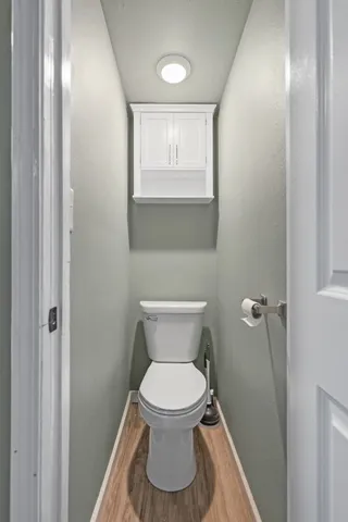 a bathroom with a toilet and a window