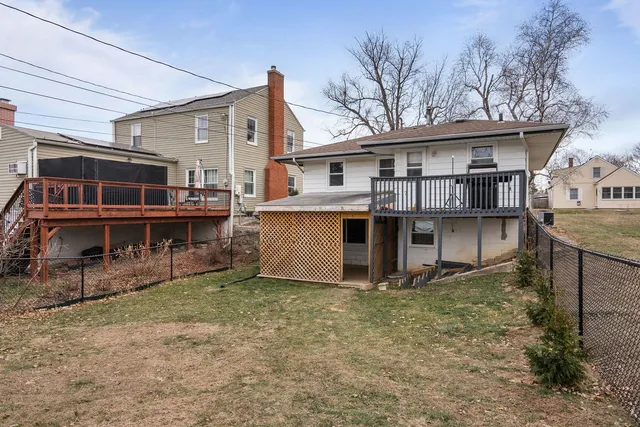 a view of a house with wooden fence