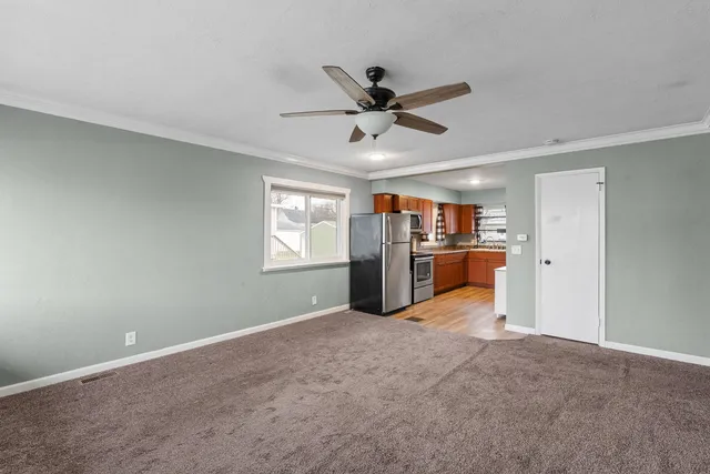 a view of a livingroom with a fireplace and a window