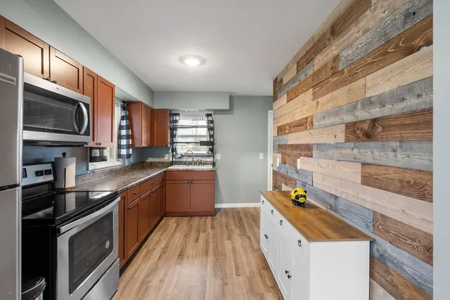 a kitchen with stainless steel appliances granite countertop a stove and a refrigerator