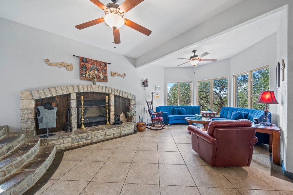 209 Lakeview Circle Spring Branch, TX 78070 - Photo 5 of 40 Tiled living room with a glass covered fireplace