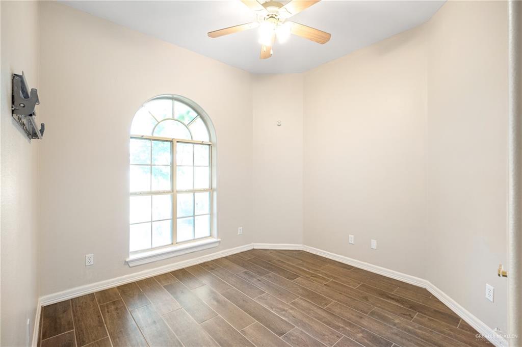 3814 B Shea Weslaco, TX 78596 - Photo 12 of 43 an empty room with wooden floor chandelier and window