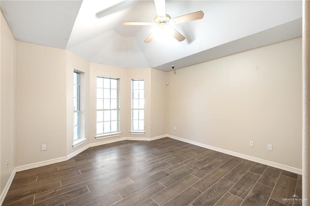 3814 B Shea Weslaco, TX 78596 - Photo 15 of 43 an empty room with wooden floor and windows