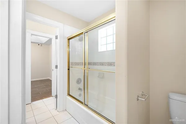 a view of a room with wooden floor and a ceiling fan