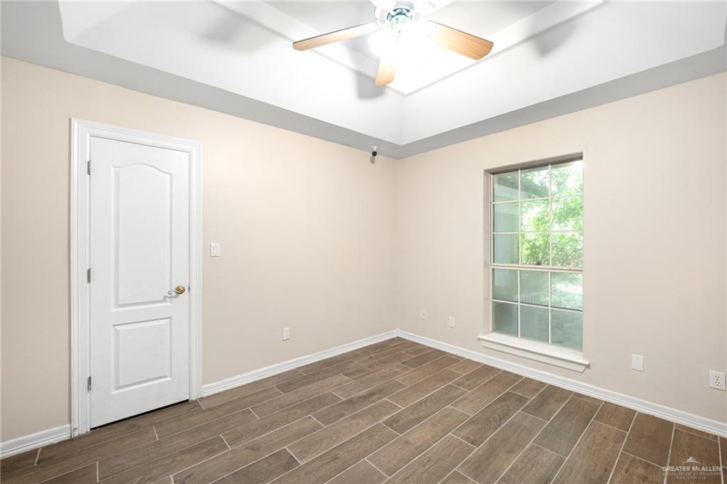 3814 B Shea Weslaco, TX 78596 - Photo 22 of 43 en empty room with wooden floor and windows