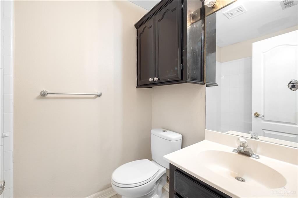 3814 B Shea Weslaco, TX 78596 - Photo 24 of 43 a bathroom with a sink a toilet and mirror