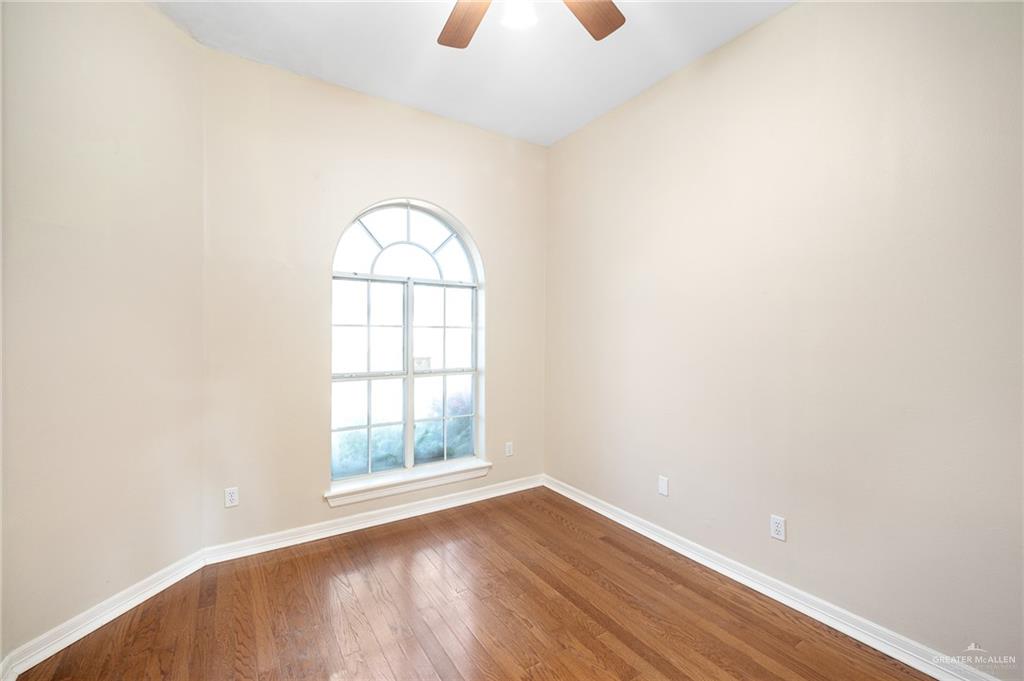 3814 B Shea Weslaco, TX 78596 - Photo 26 of 43 an empty room with wooden floor and windows
